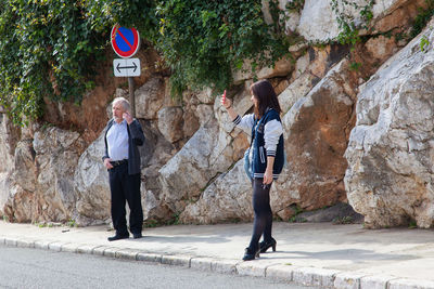 Full length of woman standing on tree trunk