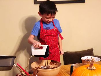 Full length of a man holding food on table