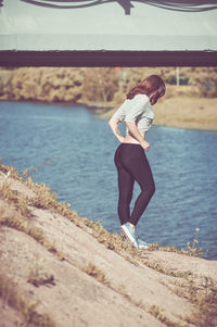 Full length of woman standing in water