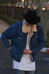 Woman wearing jacket while standing on road