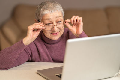 Senior woman looking at laptop