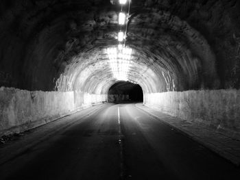 Illuminated tunnel at night