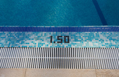 High angle view of numbers on poolside at swimming pool