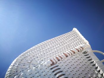 Low angle view of metallic structure against blue sky