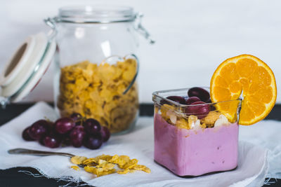 Close-up of fruits in glass jar on table