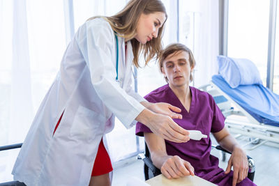 Female doctor examining patient in hospital