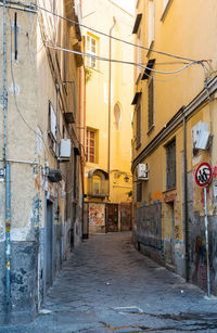 View of narrow street between old residential building