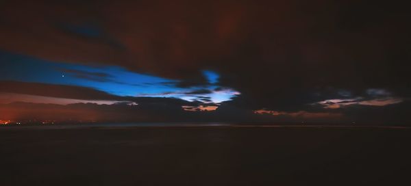 Scenic view of landscape against sky at dusk