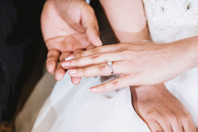 Midsection of couple holding hands
