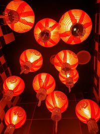 Low angle view of illuminated lanterns hanging on ceiling