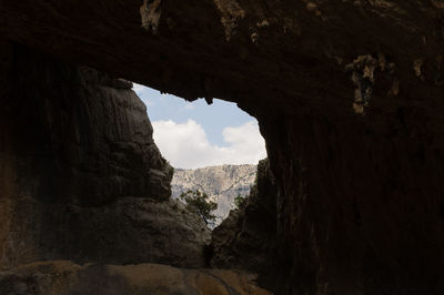 Low angle view of rock formation against sky