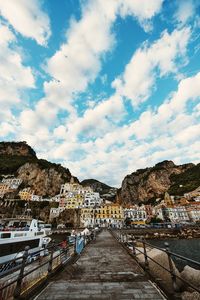 View of townscape against cloudy sky