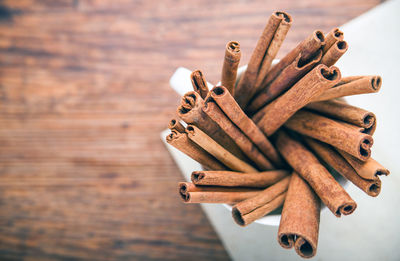 High angle view of cinnamons in cup on table