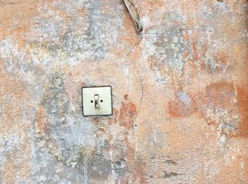 Old switch on a textured wall