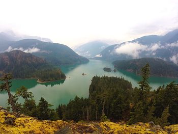 Scenic view of lake and mountains against sky