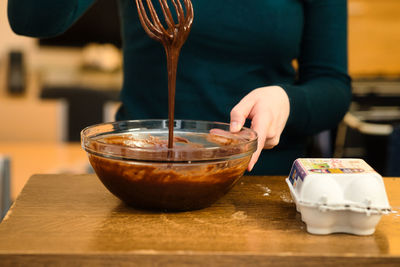 Midsection of person preparing food in restaurant