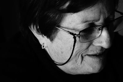 Close-up of woman over black background