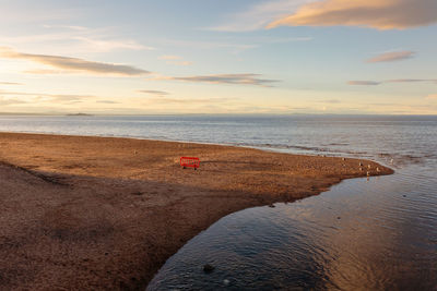 Scenic view of beach against sky during sunset