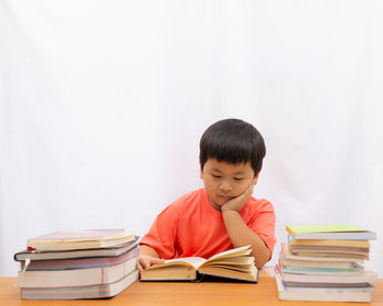 Full length of a boy sitting on table