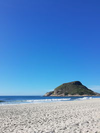 Scenic view of sea against clear blue sky