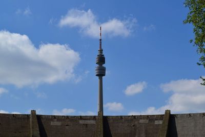 Low angle view of communications tower against sky