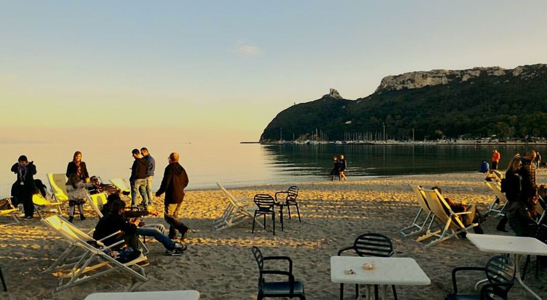 PEOPLE AT BEACH AGAINST SKY