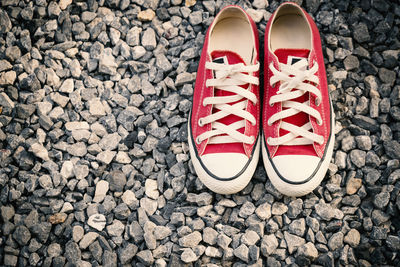 High angle view of canvas shoes on stones