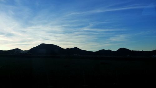 Scenic view of silhouette mountains against sky