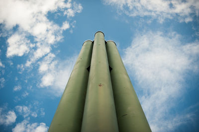 Low angle view of pipes against blue sky