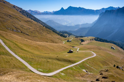 A view of a valley from the mountaintop on a sunny day with some mist 