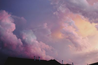 Low angle view of building against cloudy sky