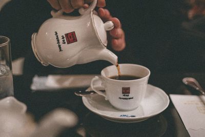 Close-up of hand holding coffee cup