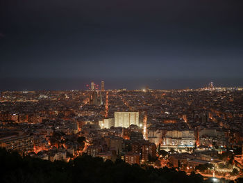 High angle view of city lit up at night