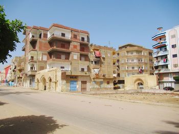 Buildings in city against clear sky