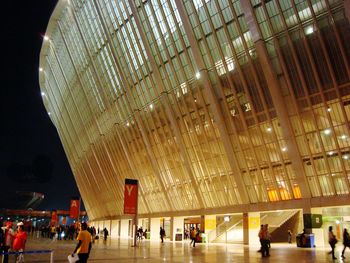 People walking in modern building at night