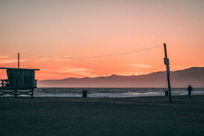 Scenic view of beach against sky during sunset