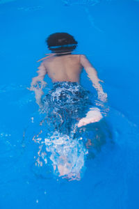 High angle view of boy swimming in pool