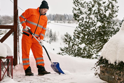 Man standing on snow covered trees