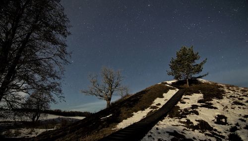 Scenic view of snow covered landscape against sky at night