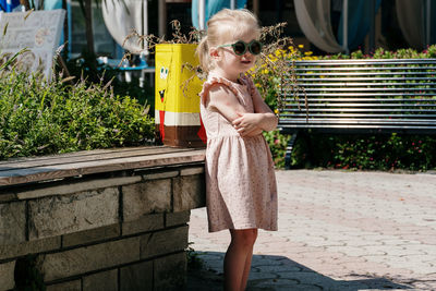 Little girl pose next to sponge bob trash bin