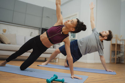 Full length of woman exercising in gym