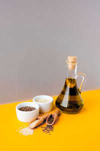 Sesame and flax seeds wooden spoons with oil in glass bottle. healthy food concept. vegan keto diet.