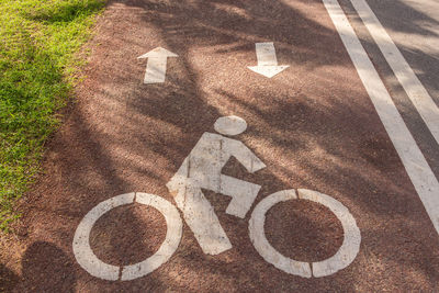 High angle view of arrow symbol on road