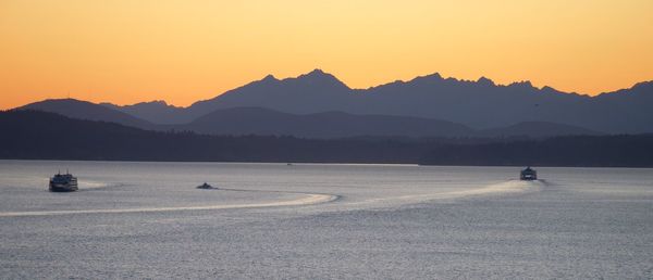 Scenic view of lake against clear sky during sunset