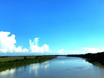 Scenic view of lake against blue sky