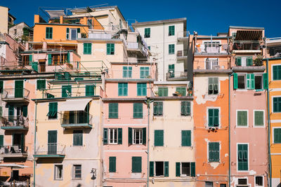 Low angle view of residential buildings against blue sky