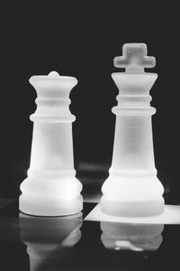Close-up of chess pieces against black background