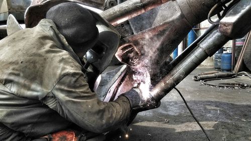 Rear view of welder working