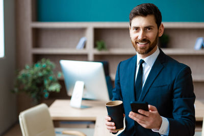 Portrait of businessman using mobile phone