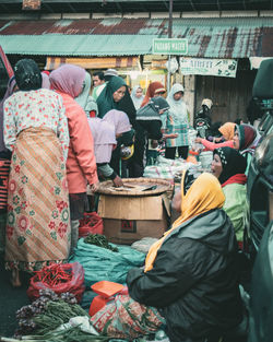 People working at market stall